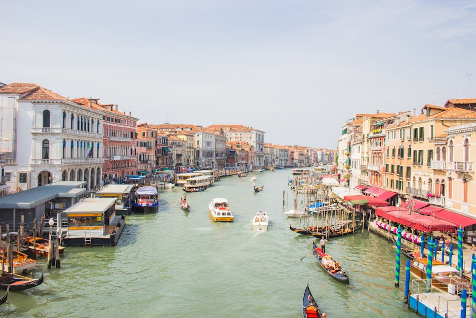 A lively view of Venice's Grand Canal featuring gondolas and historic architecture