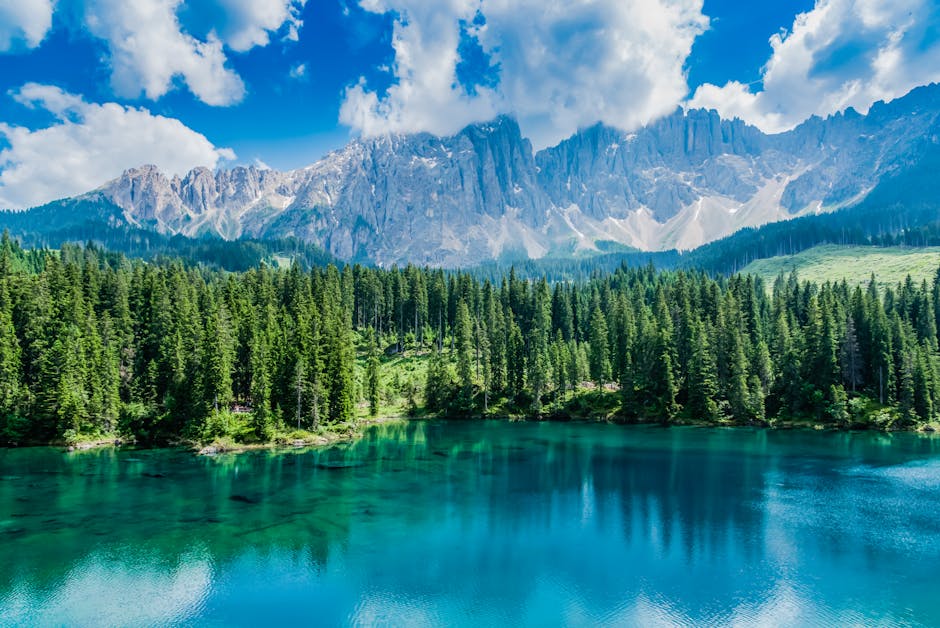 Breathtaking view of Italian alpine lake with majestic mountains and lush forest