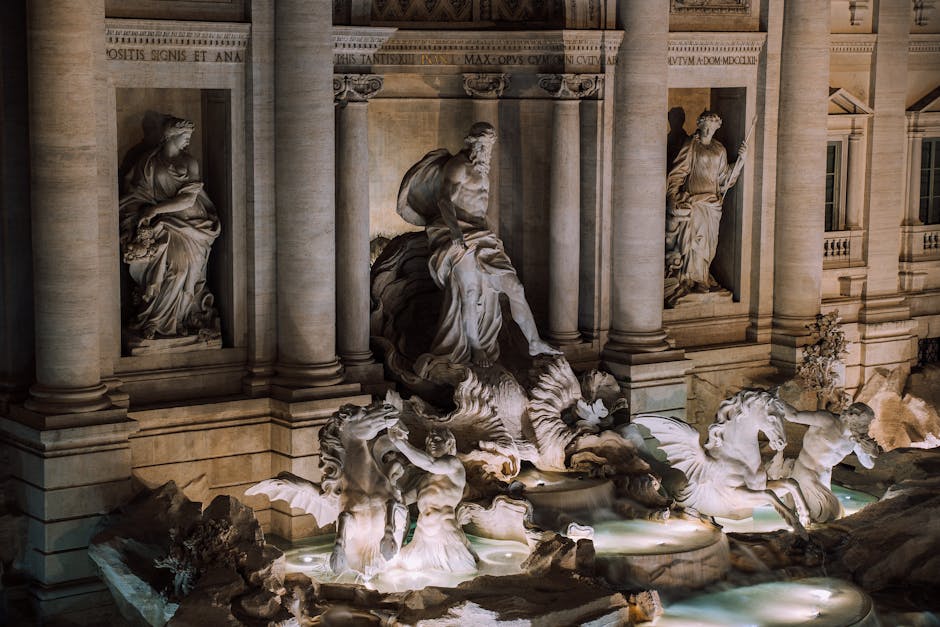 A stunning night view of the iconic Trevi Fountain in Rome, showcasing its intricate sculptures